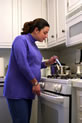 Expectant mother cooking over a stove