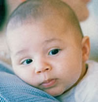 male caucasian infant on mother's shoulder